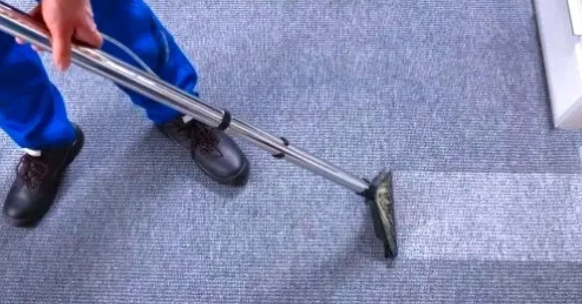 Technician extracting dirt from a commercial carpet
